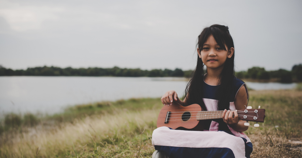 kid playing ukulele