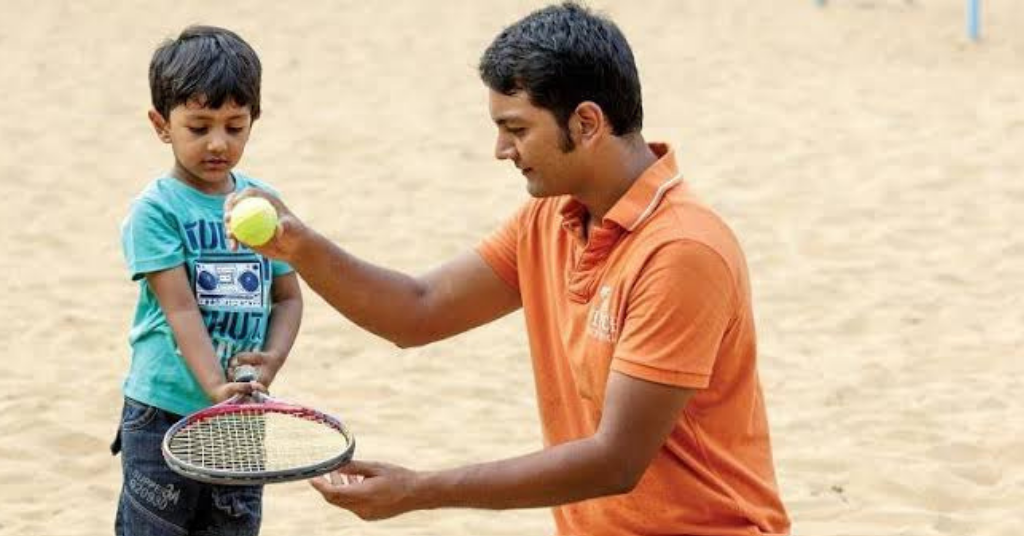 father teaching child badminton