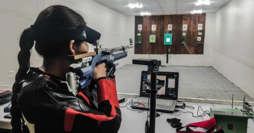 A girl is aiming to shoot to the target