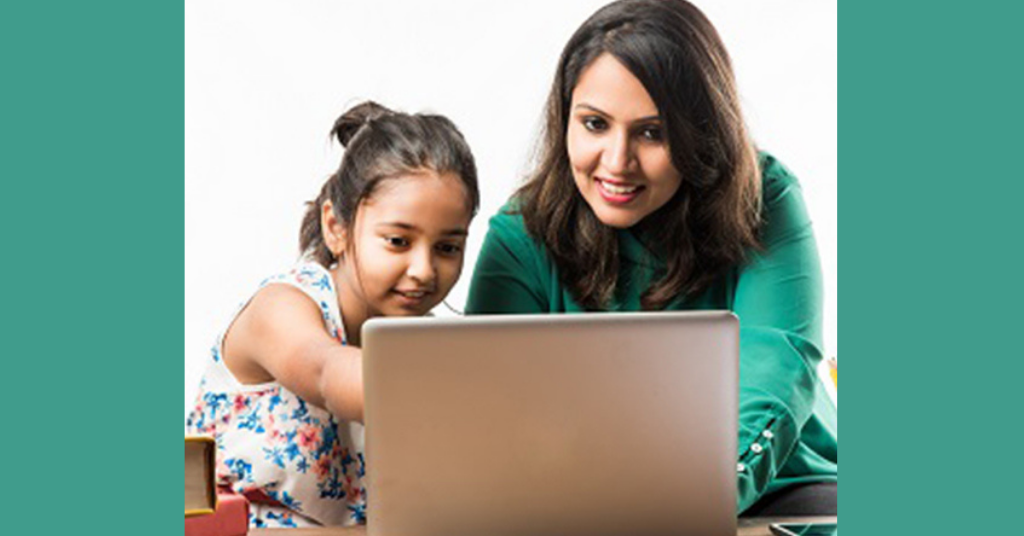A mother and daughter working on laptop