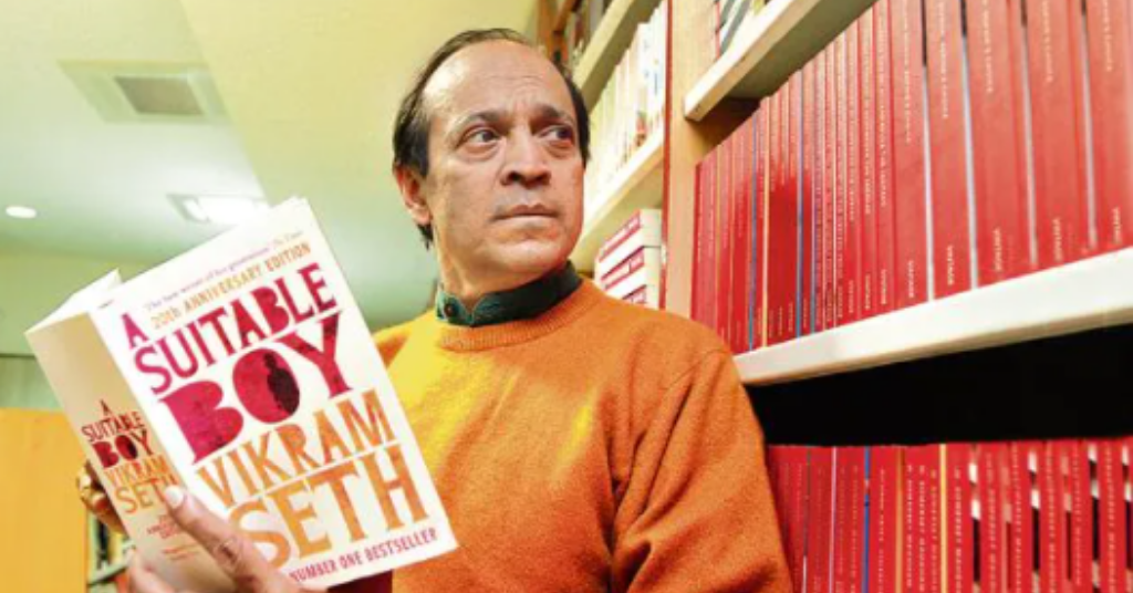 Vikram Seth holding his book