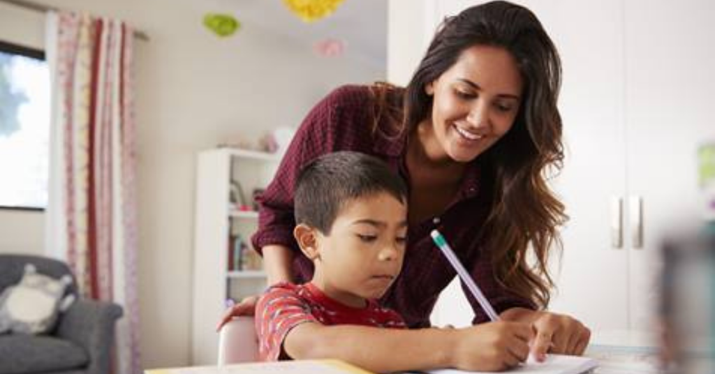 mother helping child complete a sum