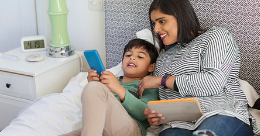 mother playing video game with her son