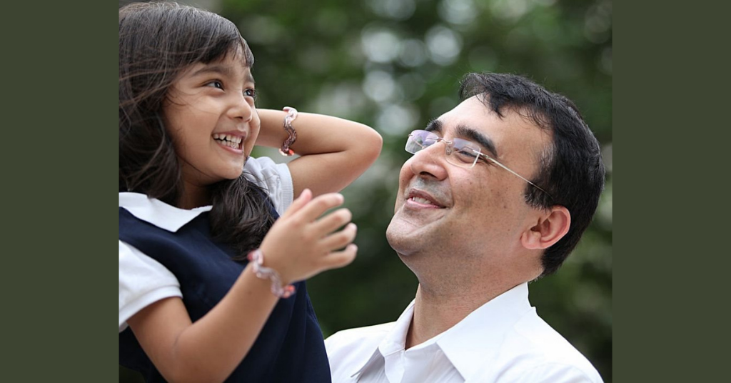 father and daughter smiling