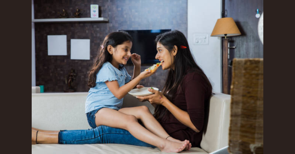 A mother and daughter eating together and spending quality time