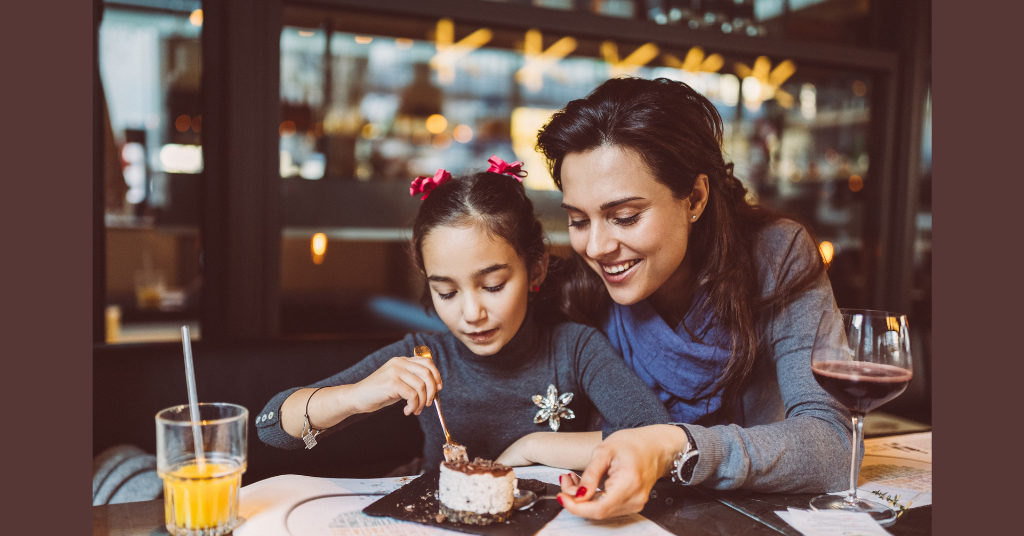 mother and daughter eating dessert
