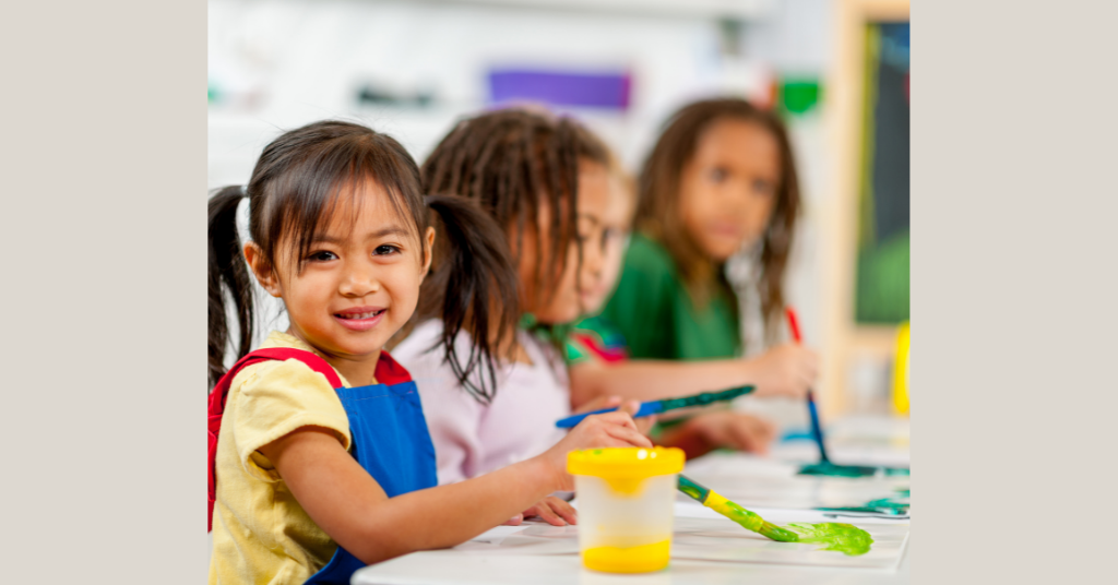 girl painting and smiling