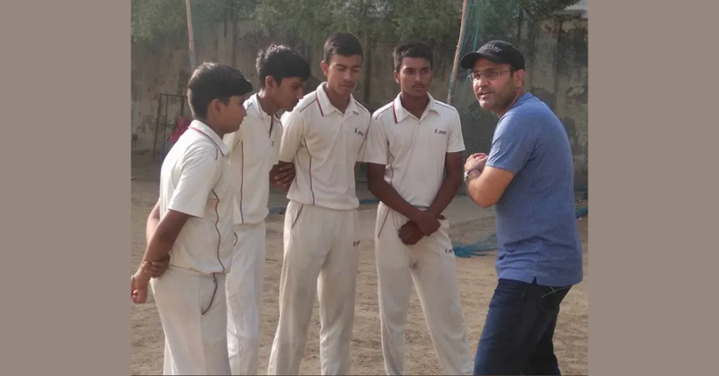 Sehwag teaching batting skills to kids