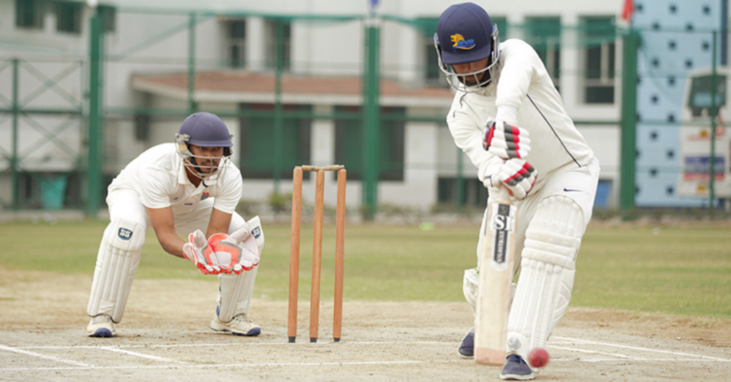 a young boy batting