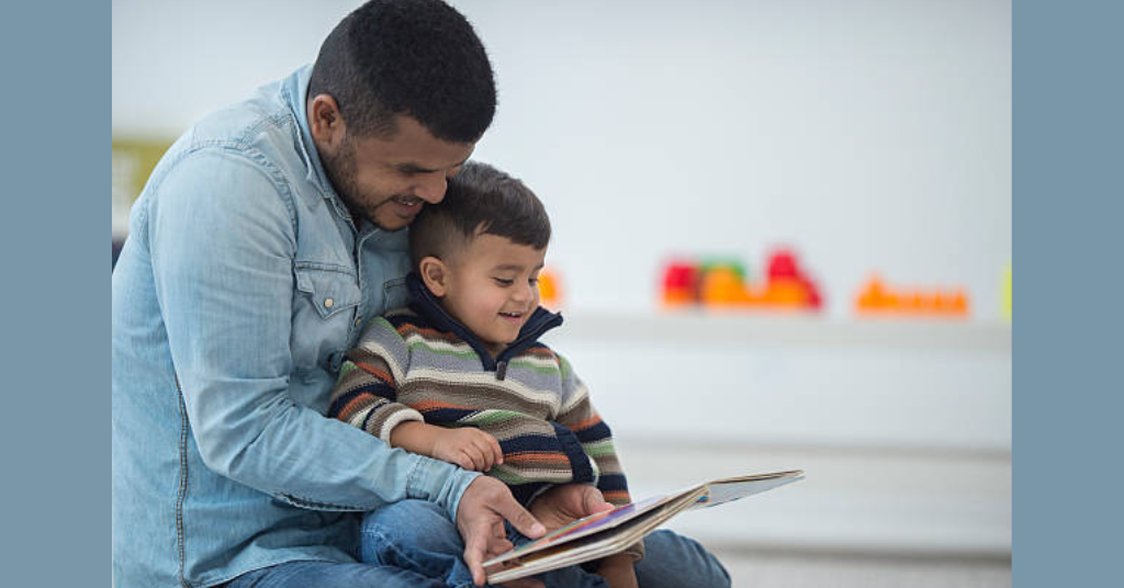 Father and son seeing family photo album