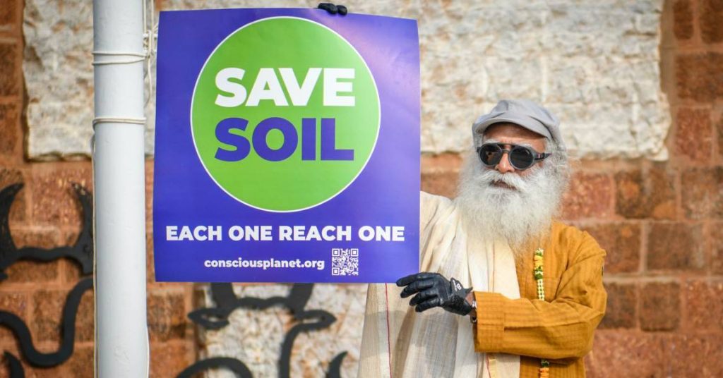 Sadhguru Holding the Poster of Save Soil Campaign