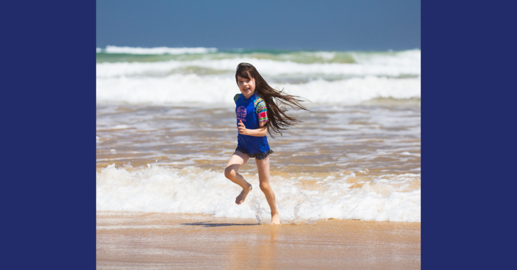 a little girl running on the beach