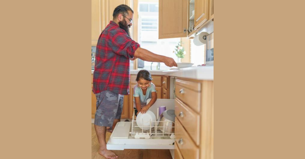 a father and daughter working in kitchen