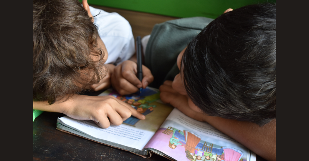 Two kids reading & writing at their play date