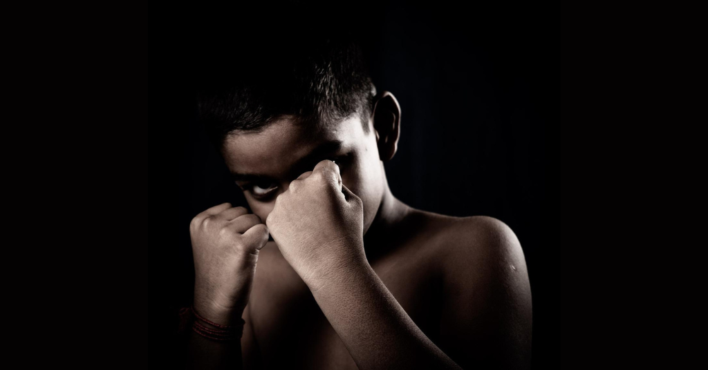 A kid posing as a boxer.