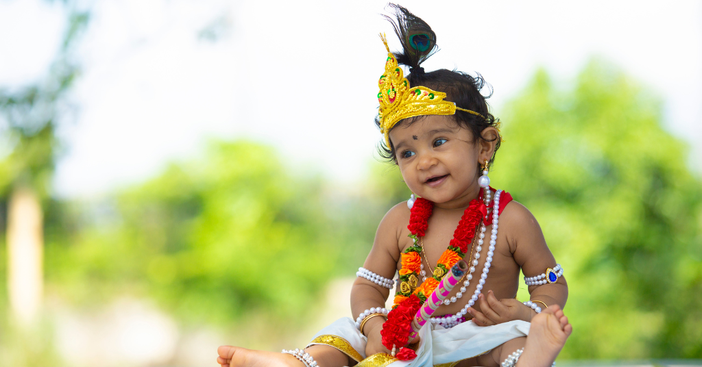 A kid dressing up like Lord Krishna