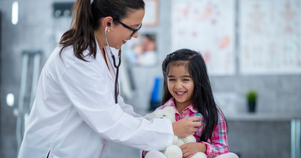 A pediatrician checking a kid's heartrate
