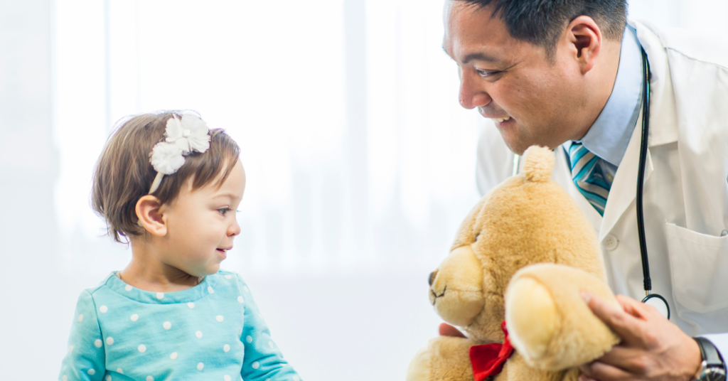 A pediatrician playing with a kid